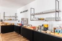 a kitchen with a counter with food on it at DELPLAZA Timbiras São Paulo in São Paulo