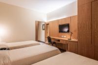 a hotel room with two beds and a television at DELPLAZA Timbiras São Paulo in São Paulo