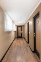 an empty hallway with doors and wood floors at DELPLAZA Timbiras São Paulo in São Paulo