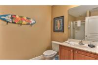 ein Bad mit einem WC und einem Surfbrett an der Wand in der Unterkunft Beach Resort 507 - Great Views Beautiful Decor Zero Entry Pool in Destin
