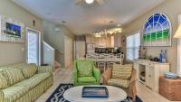 ein Wohnzimmer mit einer Couch und Stühlen und einem Tisch in der Unterkunft Biglows Bungalow - About a quarter mile to PRIVATE Neighborhood Beach Access, Pet Friendly, Community Pool in Destin