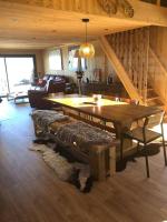 a living room with a table and a couch at Chalet au pied des pistes du Cambre d Aze in Saint-Pierre-dels-Forcats