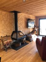 a living room with a fireplace in a log cabin at Chalet au pied des pistes du Cambre d Aze in Saint-Pierre-dels-Forcats