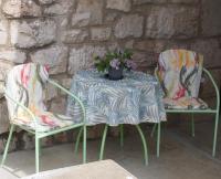 a table and two chairs with a plant on it at Apartment Nadalina in Kraljevica