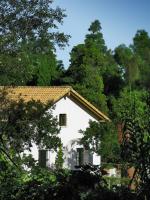 a white house with trees in front of it at Complejo Rural Huerta Grande in Algeciras