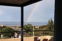 a rainbow over the ocean from a balcony at Estaque Cozy nest with a magical view of the sea in Marseille
