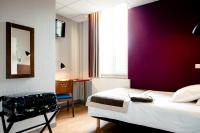 a bedroom with a bed and a purple wall at Domaine Lyon Saint Joseph in Sainte-Foy-lès-Lyon