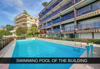 a swimming pool of the building with two people standing next to it at Nestor&amp;Jeeves - HUBLOT TERRASSE - Sea view - swimming pool in Nice