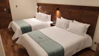 Ein Bett oder Betten in einem Zimmer der Unterkunft Muña Hotel Andahuaylas