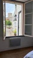 a bedroom with a window with a view of a street at Appartement cœur de ville in Châtillon-sur-Indre