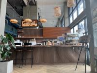 a fast food restaurant with a bar with stools at De Botan Bangna in Bangkok