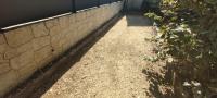 a walkway leading into a brick wall with a plant at Chambre d&#39;hôte Amouratcha in Fabrègues