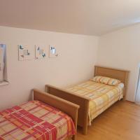 a bedroom with two beds and a comforter at Dee&#39;s House and Pool in Labin