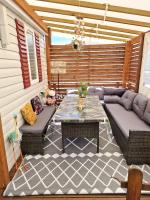 a patio with two couches and a table on a patio at Bungalow de 3 chambres avec piscine partagee et terrasse a Vias a 1 km de la plage in Vias
