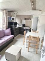 a kitchen and living room with a table and a couch at Bungalow de 3 chambres avec piscine partagee et terrasse a Vias a 1 km de la plage in Vias