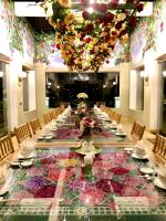 a long table in a room with flowers on it at Binh An Village Resort in Da Lat