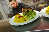 um homem sentado numa mesa com dois pratos de comida em Landgasthaus Gieseke-Asshorn em Bohmte