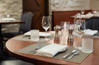 a table in a restaurant with glasses and napkins at Pine Barn Inn in Danville