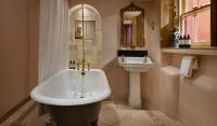 a bathroom with a bath tub and a sink at The Rookery in London