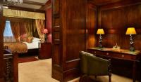 a room with a desk and a bedroom with a bed at The Rookery in London