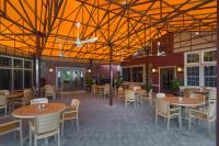 a dining area with tables and chairs and a building at Pine Barn Inn in Danville