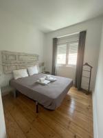 Postel nebo postele na pokoji v ubytování Penha Cozy Home