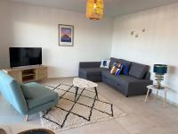 a living room with a couch and a tv at Exceptionnelle Vue Mer Calvi - Piscine - T2 in Calvi