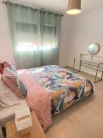 a bedroom with a bed with a colorful blanket at Exceptionnelle Vue Mer Calvi - Piscine - T2 in Calvi