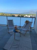 two chairs and a table on a balcony at Exceptionnelle Vue Mer Calvi - Piscine - T2 in Calvi