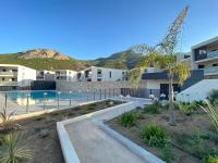 a view of a building with a swimming pool at Exceptionnelle Vue Mer Calvi - Piscine - T2 in Calvi