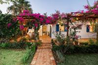 a garden with a pergola filled with pink flowers at Villa in the Garden in Kokkini Khanion