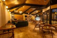 a restaurant with wooden ceilings and tables and chairs at Arcadia Heritage Resort in Darjeeling