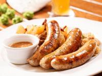 a plate of sausages and potatoes with a dipping sauce at CHALET ELISTHUR in Saint-Jean-d&#39;Aulps