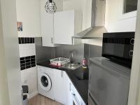 a kitchen with a sink and a washing machine at Studio de charme in Pantin