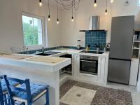 a kitchen with a sink and a stove top oven at LE CLOS DE FLO 17 in Saint-Rogatien
