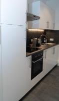 a kitchen with white cabinets and a stove top oven at Beau T2 quartier Contades in Strasbourg