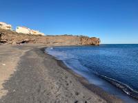 a beach with rocks and the ocean on a clear day at CAP D&#39;AGDE studio cabine 6 pers. + terrasse + parking privé + clim (calme) in Cap d&#39;Agde