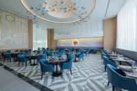 a dining room with blue chairs and tables at Siam Mandarina Hotel - Free BKK Airport Shuttle in Lat Krabang