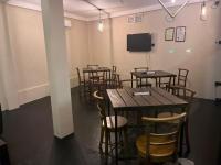 een kamer met tafels en stoelen en een flatscreen-tv bij ORENDA ECO LODGE & SPA in Galle