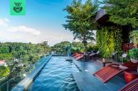 a pool with chairs and a table in the water at Silverland Yen Hotel in Ho Chi Minh City