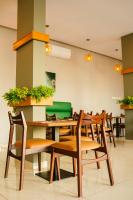 a dining room with wooden tables and chairs at Destination Beach Hotel by Dreamworld in Karachi