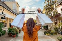 a woman holding up two white umbrellas in a street at House with garden Disneyland Paris in Magny-le-Hongre