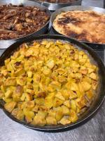 a pan filled with food on a table at Guesthouse Kevin in Kukës