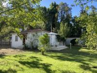 a small white house in the middle of a yard at Mas des catalanes dépendance privé climatisation, wifi 2MASCAT39 in Perpignan