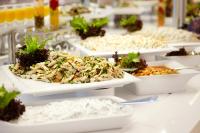 a table topped with white dishes filled with food at Orka Lotus Beach in Marmaris