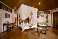 a living room with a bed and a table at Mandala Spa &amp; Resort Villas in Boracay