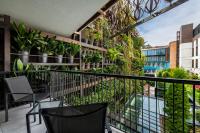 a balcony with chairs and plants on a building at IOTA Hotel Tbilisi in Tbilisi City