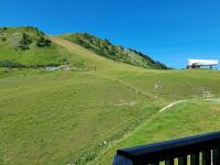 a grassy hill with a building on top of it at Studio Plagne Aime 2000, 1 pièce, 4 personnes - FR-1-181-2618 in Aime-La Plagne