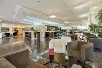 a lobby with couches and chairs and a piano at Austria Trend Hotel Congress Innsbruck in Innsbruck