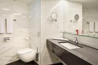 a white bathroom with a toilet and a sink at Austria Trend Hotel Congress Innsbruck in Innsbruck